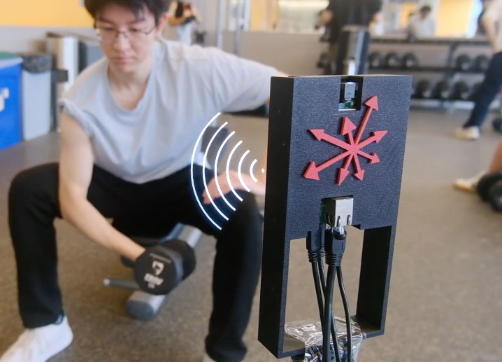 A man does bicep curls with a dumbbell while a wireless device monitors his progress.